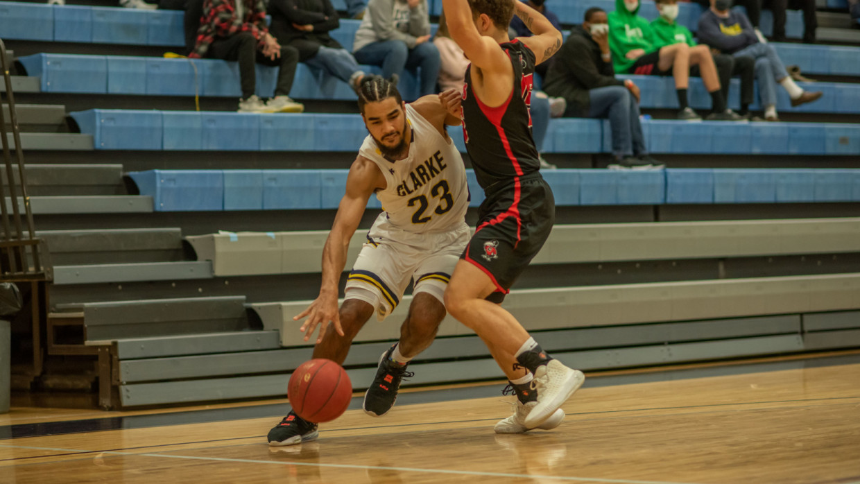Keith Johnson driving by guarding defender
