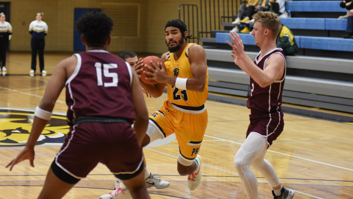 Keith Johnson driving towards the basket against defenders